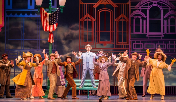 Noah Racey (center) as Harold Hill with the company of Meredith Willson’s The Music Man at The 5th Avenue Theatre. Photo: Mark Kitaoka