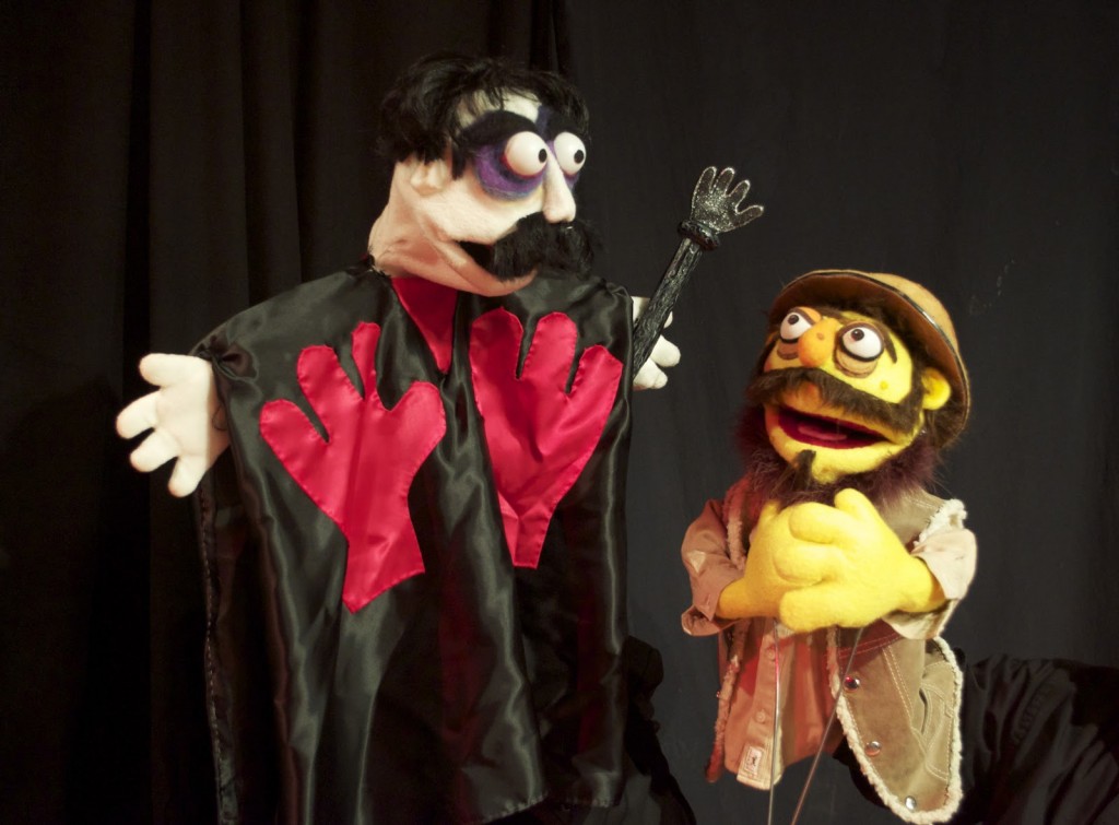 The Master disciplines his loyal servant, Torgo.  Puppets by Rachel Jackson and Paul Velasquez. Photo by Bob Koerner.
