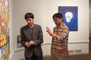 Mr. [right] explaining a piece with help from a curator.